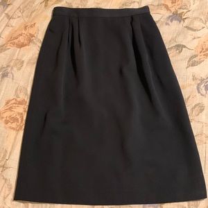 Black lined polyester skirt, size 8, with pleats in the front